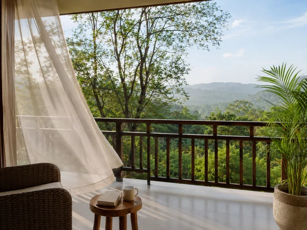 Breezy private balcony surrounded by trees and mountain views