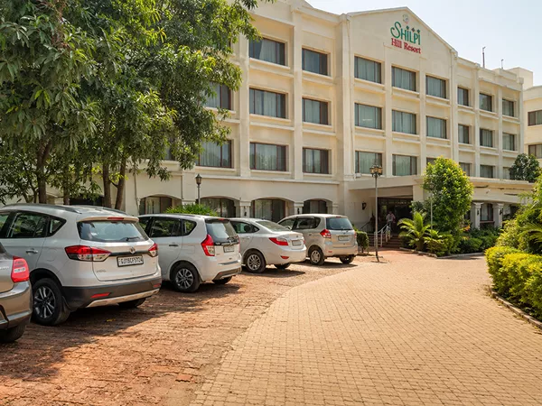 Spacious hotel parking area with cars near the property